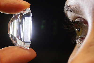 A staff member holds a 100-carat perfect diamond in a classic emerald-cut at Sotheby's auction house in central London